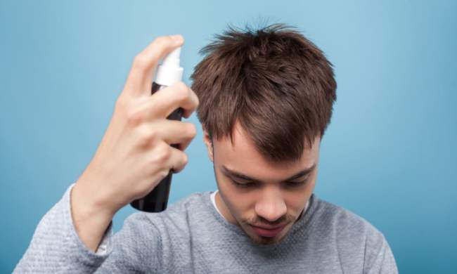 Man spraying his hair