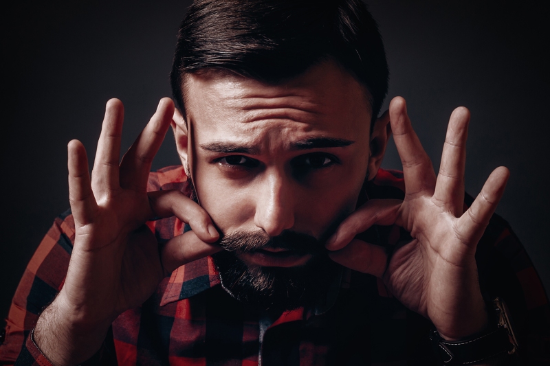 Man waxing his mustache