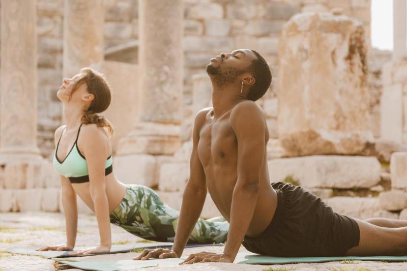 Man and woman doing yoga.